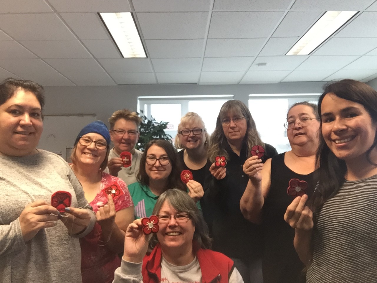 Participants holding their beaded poppies 